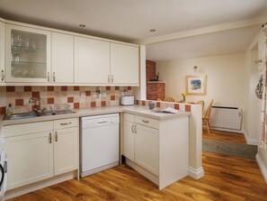 A compact kitchen with white cabinetry, a dishwasher, and a tiled backsplash. - A perfect retreat for couples or families to really kick back, relax and enjoy. (Wooton Fitzpaine, near Charmouth)