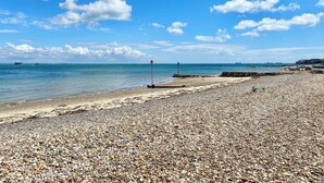 A pebbled beach with a clear sky and calm sea. - 2 bedroom accommodation in Seaview (Seaview)