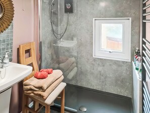 A bathroom with a shower, a sink, a chair, and a window. - Rowan Tree Lodge - UKC6977 (Ludlow)