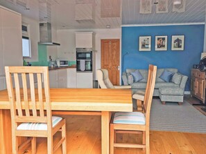 A compact living space with a dining area, kitchenette, and seating area. - Dinky Daze - UKC7071 (Brundall)
