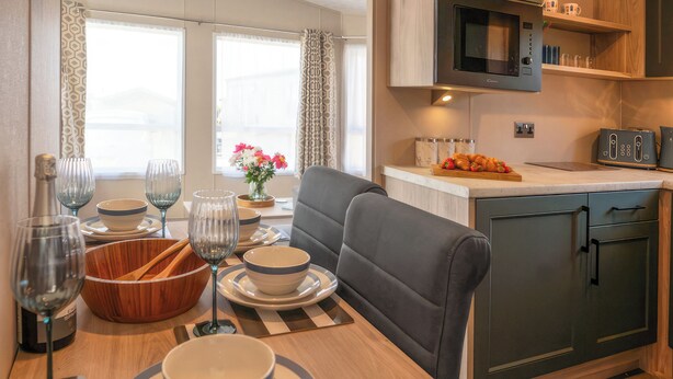 A compact kitchenette with a microwave, toaster, and a small countertop. - 18 Ocean Terrace - UKC7117 (Ilfracombe)