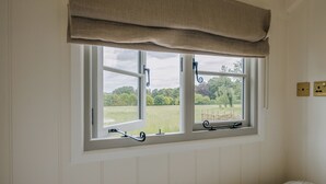 A room with a window, a bed, and a radiator. - UK41468 - Lapwing Hut (Cholderton, near Salisbury)