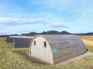 A wooden structure with a curved roof, a small window, and a sign labeled 'DOUGIE.'
