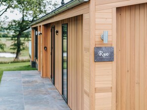 A wooden building with a sign reading 'Rue' on the wall.