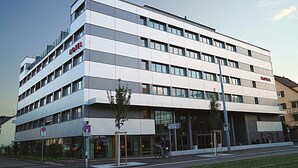 A modern hotel building with a flat facade, multiple windows, and a prominent 'HOTEL' sign. - H Hotel Zurich (Zürich)