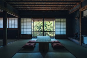 A traditional Japanese room with tatami flooring, a low wooden table, and shoji screens. - HOTEL RACCAN (Shibushi)