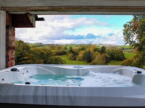 A hot tub with a view of a countryside landscape. - 1 bedroom accommodation in Aberhafesp, near Newtown (Newtown)