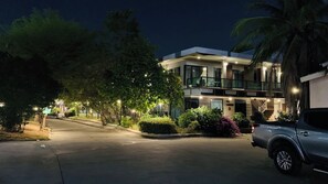 A modern hotel with a well-lit entrance, a covered parking area, and a visible number '3' on the building. - Tamnan Resort Pattaya (Pattaya)