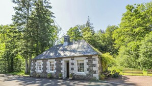 A stone building with a pitched roof, surrounded by trees. - 1 bedroom accommodation in Kirkmichael, near Ayr (Kirkmichael, near Ayr)