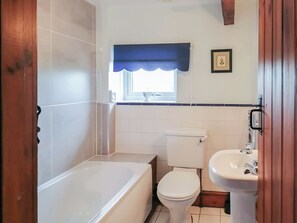 Ein Badezimmer mit Badewanne, Toilette und Waschbecken.