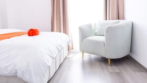 A hotel room with a bed, a chair, and curtains. - Cozy 2-bedroom apartment in perfect Nairobi with fitness room WESTLANDS (Nairobi)