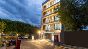 A multi-story building with a modern architectural design, featuring balconies and large windows. - Yashobhoomi Suites near Yashobhoomi Convention Centre (New Delhi)