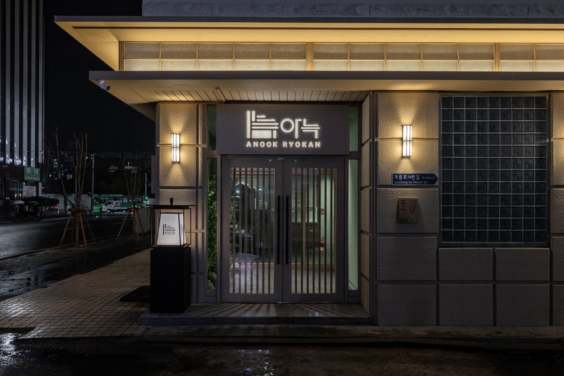 A building with a sign reading 'ANOOK RYOKAN' and a small sign indicating the address 'Gyeongryong-ro 74beon-gil.'