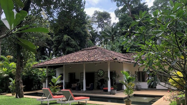 A house with a tiled roof, a covered porch, and a swimming pool. - Leonora House, Talpe (Galle)