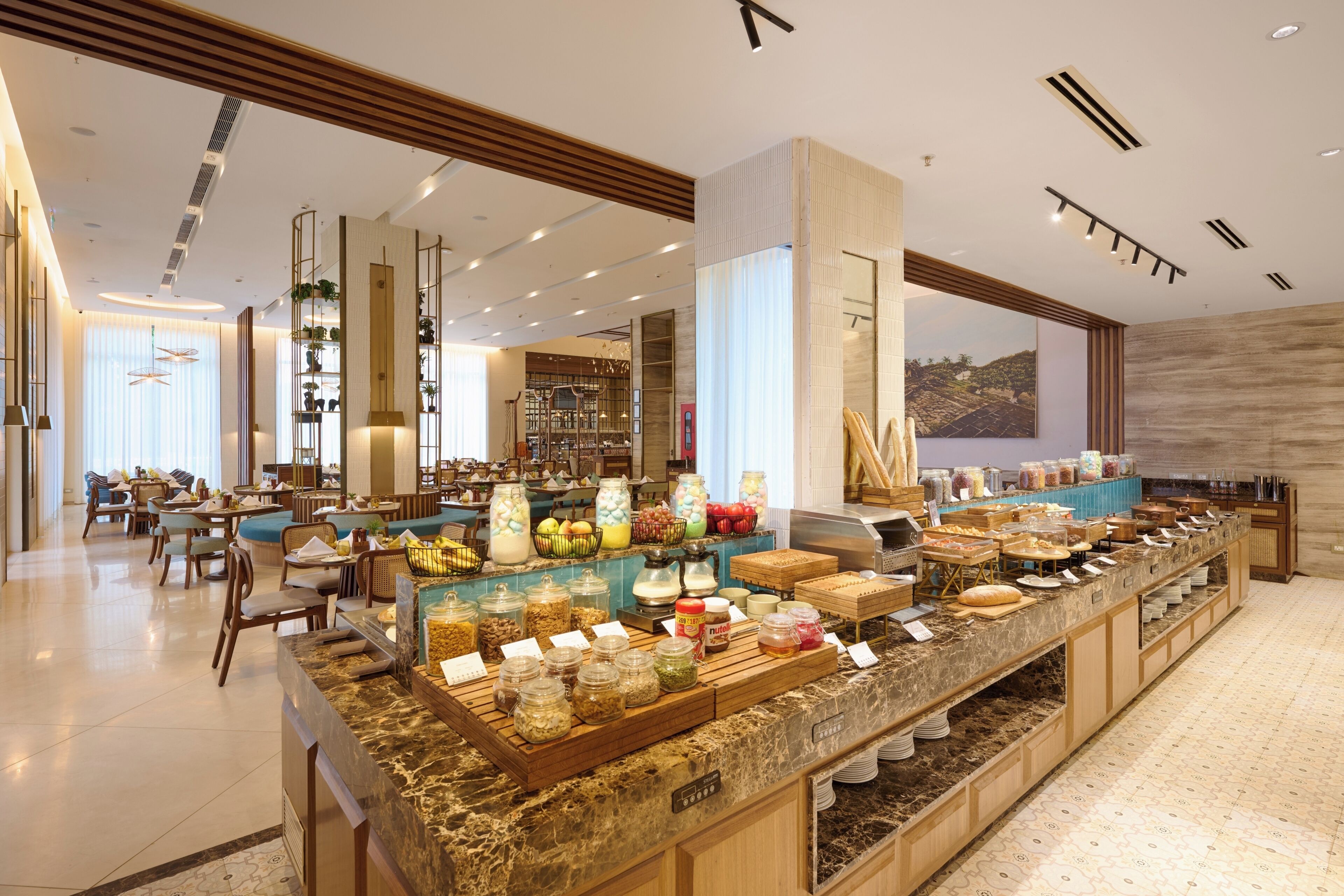 A buffet area with various food items and a seating area with tables and chairs.