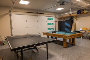 A billiards room with a pool table, a snooker table, and a dartboard. - Cozy 2-bedroom cabin in adorable Deming with AC (Deming)