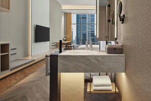 A modern hotel room with a large window, a flat-screen TV, a bathtub, and a vanity with a mirror. - AC Hotels by Marriott Hangzhou (Hangzhou)