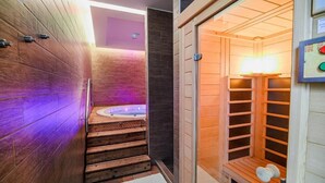 A modern spa area with a wooden sauna, a hot tub, and a steam room. - Glamping Malerič with Natural Pool (Črnomelj)