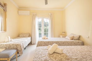 A hotel room with two beds, a desk, a chair, and a window with curtains. - Family Villa for 7 Mijas Golf With Pool (Mijas)