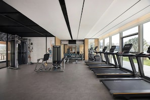 A gym with treadmills, weight machines, and dumbbells. - Four Points by Sheraton Chongqing Jiangjin (Chongqing)