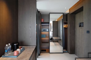 A modern hotel lobby with a reception desk, a coffee machine, and a digital screen. - Four Points by Sheraton Hefei, Qirui (Hefei)