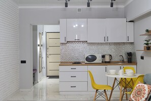 Comfort Apartment, Courtyard View | Private kitchen | Full-size fridge, microwave, stovetop, highchair - One Bedroom Apartment (Almaty)