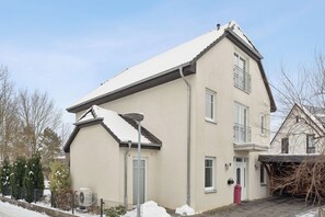A two-story building with a sloped roof, a visible chimney, and a small porch area. - Studio apartment near Hanover - Trade fair & business | Quiet & modern in Sehnde (Sehnde)