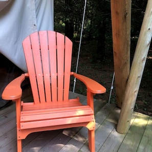 A wooden deck with a single orange Adirondack chair. - Beautiful Ontario Glamping Tent Along Lynn River (Port Dover)