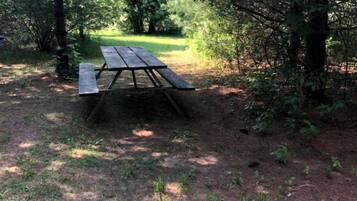 A picnic table in a wooded area.