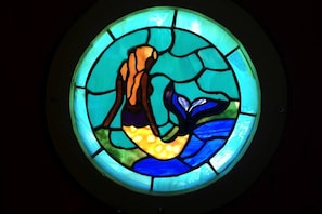A circular stained glass window with a central figure.