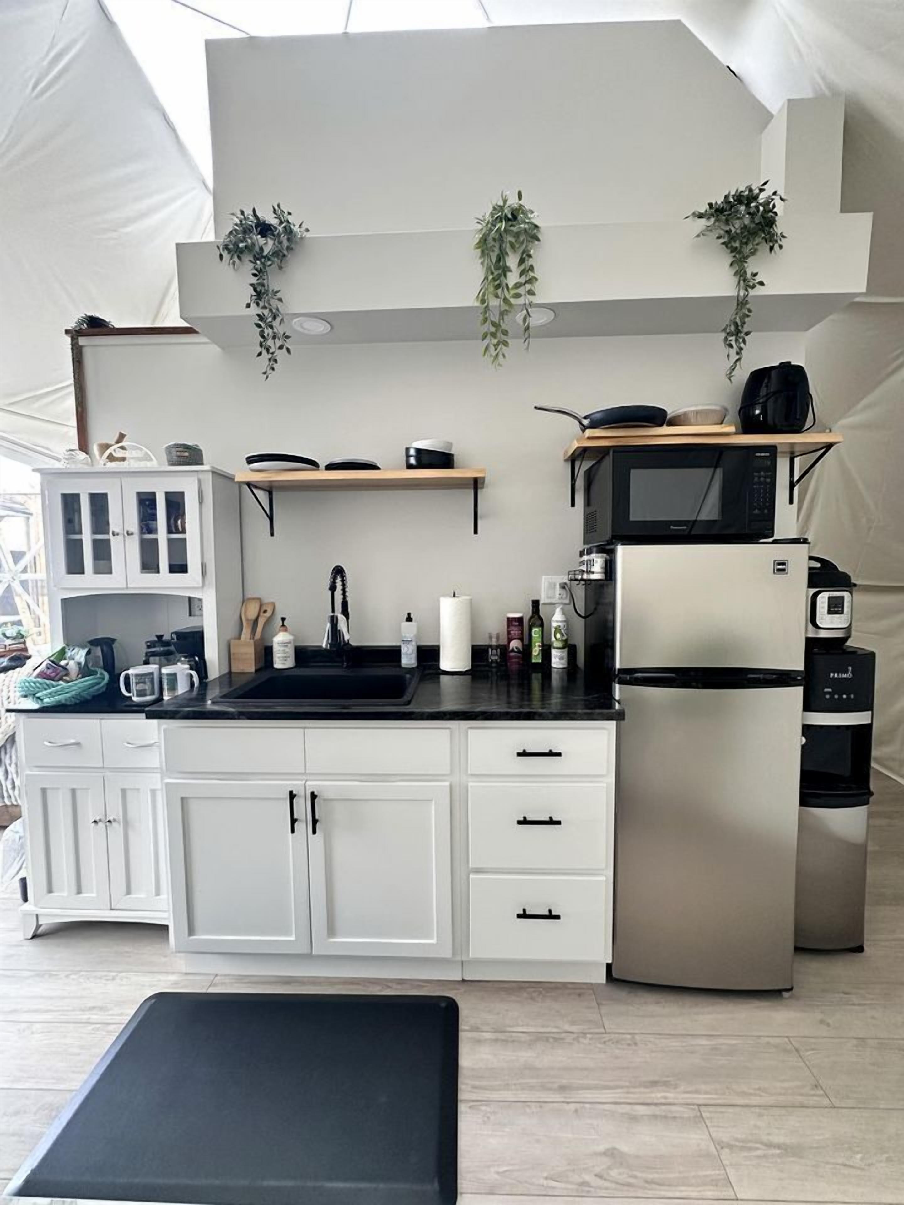 Coffee/tea maker, fridge, stovetop, cookware/dishes/utensils