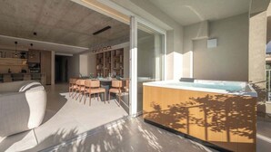 A modern interior with a kitchen, dining area, and a hot tub. - Valletta views, hot tub, sauna, ferries | AZ12 (Sliema)
