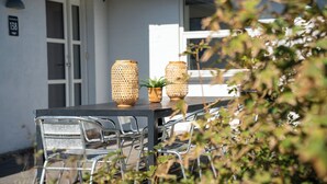 Ein Essbereich mit einem Tisch, Stühlen und zwei Korbwannen.
