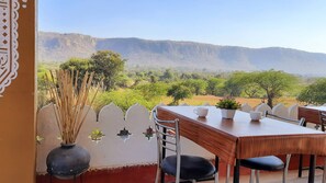 A dining area with a view of a mountainous landscape. - Ranthambhore Tiger Valley (Sawai Madhopur)