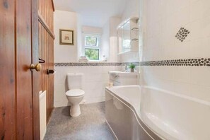 Ein Badezimmer mit Toilette, Waschbecken und Badewanne.