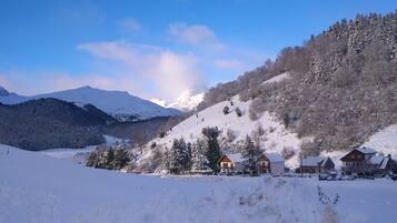 A snow-covered mountain landscape with houses on a slope.