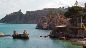 A coastal scene with rocky outcrops and a building on a hill. - Oasis of relaxation in the heart of Altavilla Milicia, located between Palermo and Cefalù. (Altavilla Milicia)