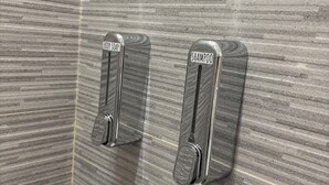 A bathroom with a textured wall and two metallic soap dispensers labeled "BODY SOAP" and "SHAMPOO". - Oasis of relaxation in the heart of Altavilla Milicia, located between Palermo and Cefalù. (Altavilla Milicia)