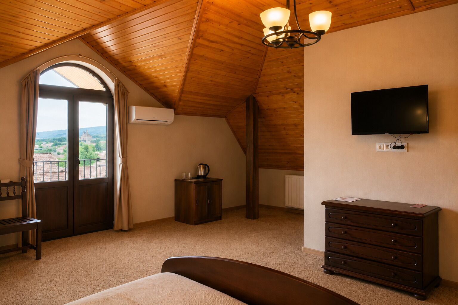 A bedroom with a wooden ceiling, a television, a dresser, and a window with curtains.