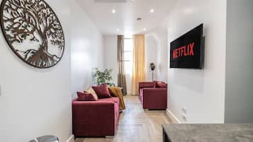 Luxury Apartment, 1 King Bed, Balcony, City View | Living area | TV