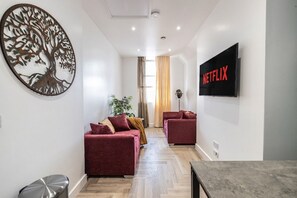 Luxury Apartment, 1 King Bed, Balcony, City View | Living area | TV