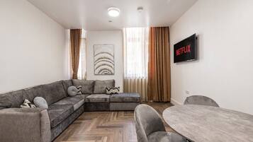 Deluxe appartement, 2 slaapkamers, op benedenverdieping | Woonruimte | Een televisie