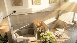 A modern interior with a sofa, a small table, and a potted plant.