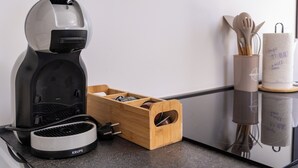 A kitchen with a coffee maker, a wooden spice rack, and a utensil holder. - Romantic Leona Apartment with Large Terrace near Dubrovnik (Orašac)
