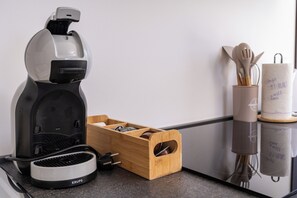 A kitchen with a coffee maker, a wooden spice rack, and a utensil holder. - Romantic Leona Apartment with Large Terrace near Dubrovnik (Orašac)