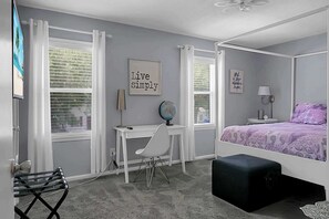 A bedroom with a four-poster bed, a desk with a globe, and a chair. - Charming Townhouse Retreat w/ Patio & Private Balcony Escape (North Charleston)