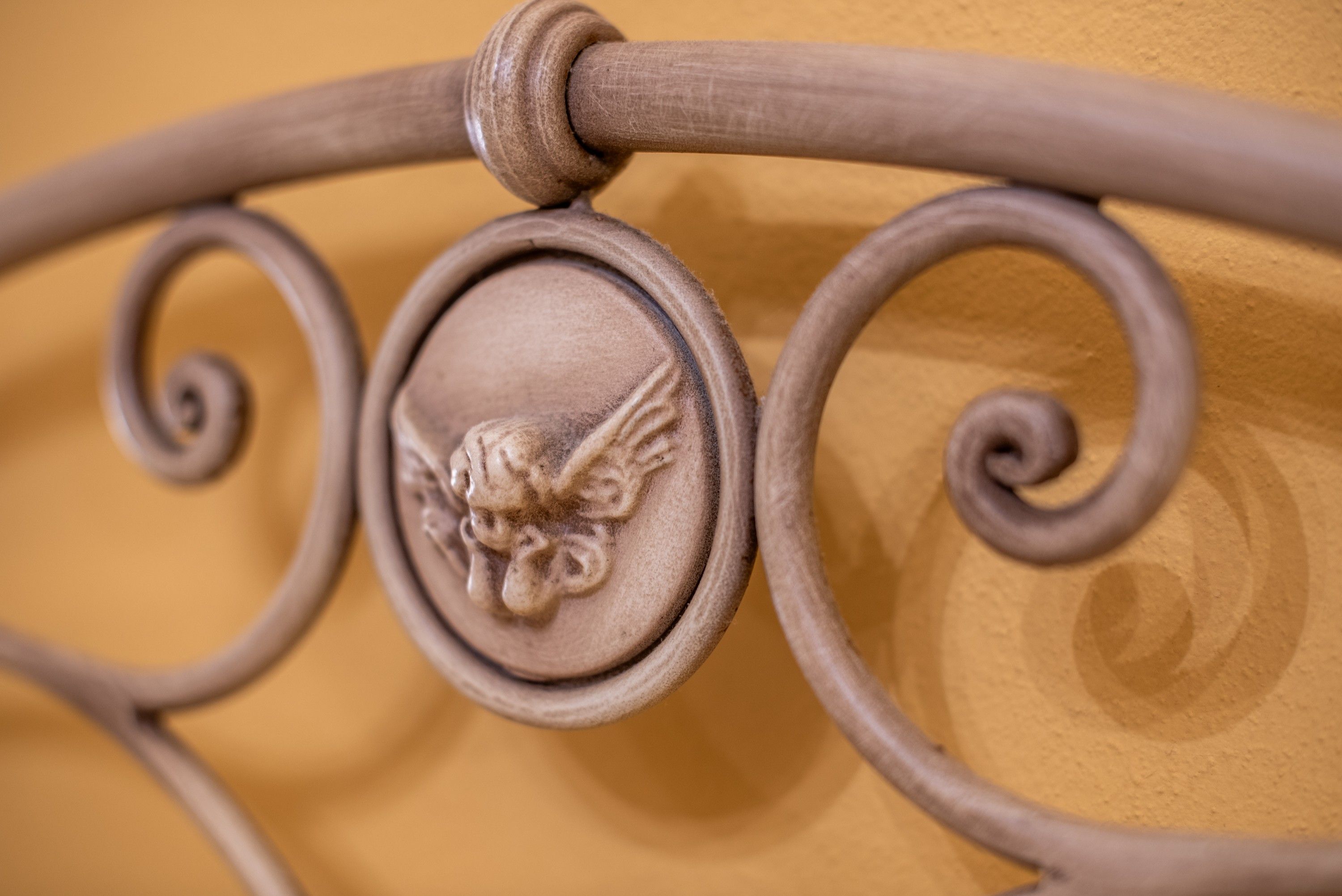 A metal bed frame with a decorative headboard.