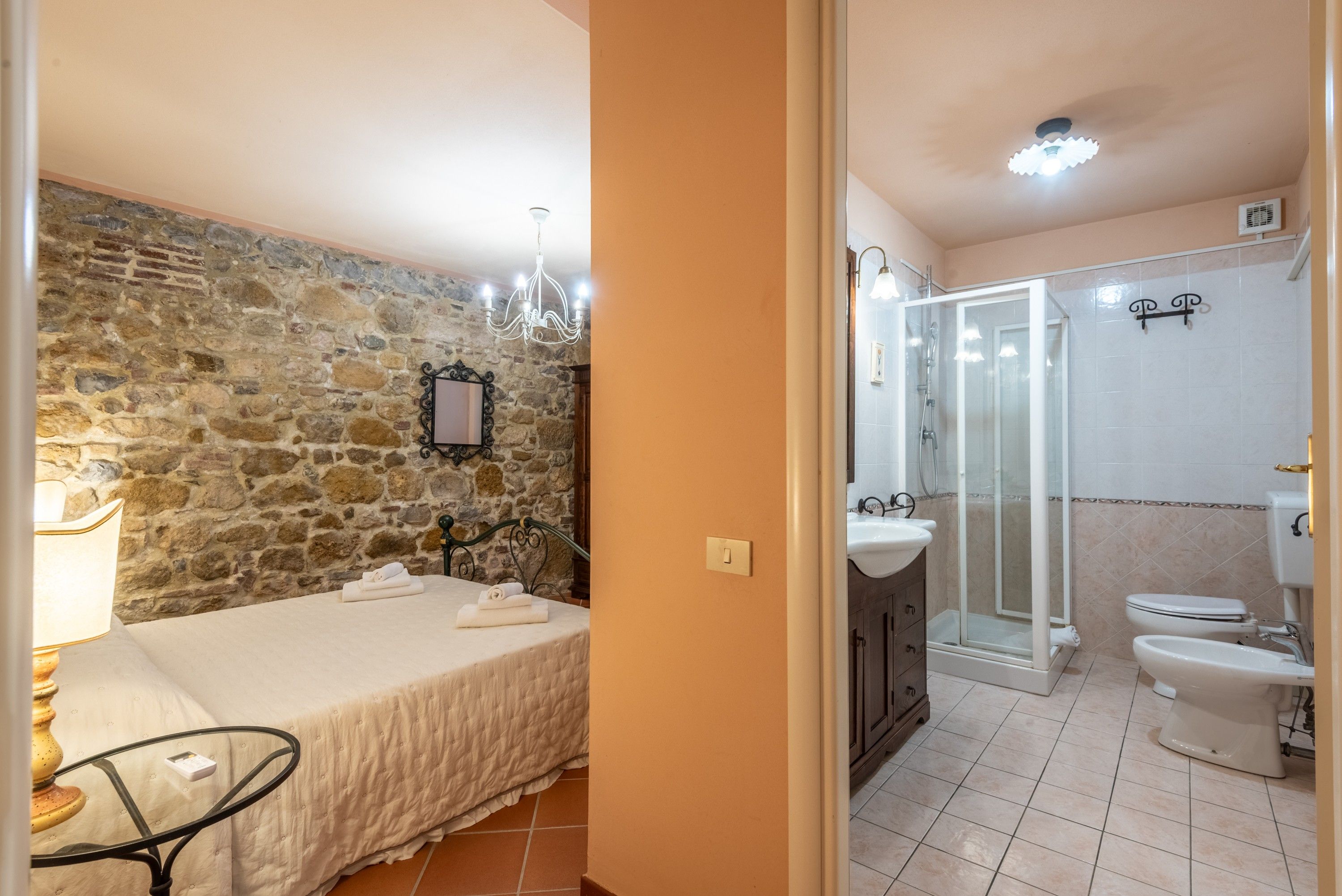 A bathroom with a shower, toilet, and sink.