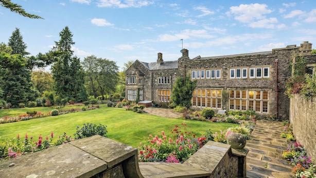 A stone building with a well-manicured lawn and a stone pathway leading to the entrance. - Hanlith Hall (Skipton)