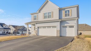 A two-story house with a garage and a driveway. - 2 Mi to National Sports Center: Blaine Base Camp (Blaine)